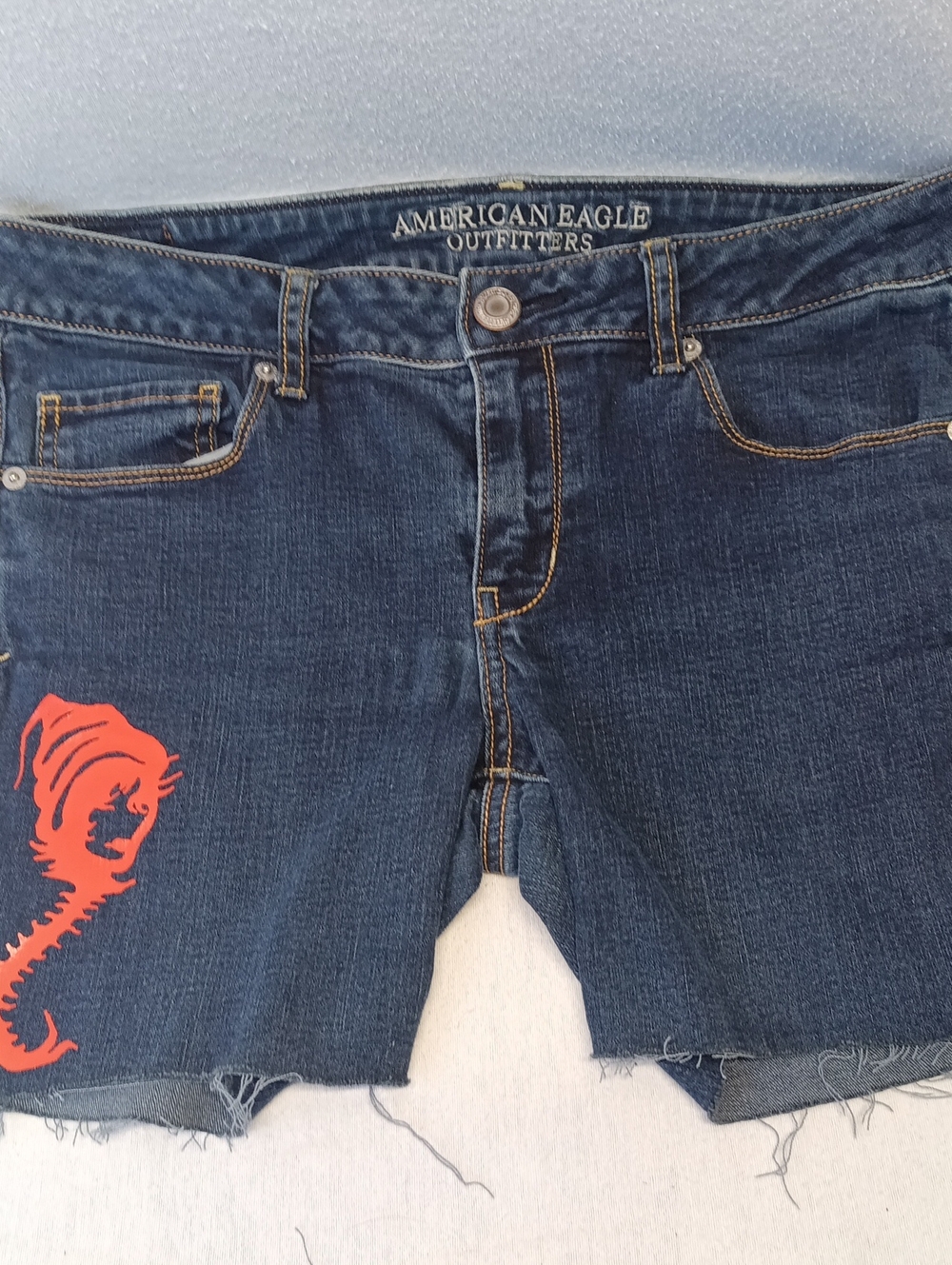 American Eagle Outfitters Dark Blue Denim Cut Off Shorts with Red-Orange Graphic